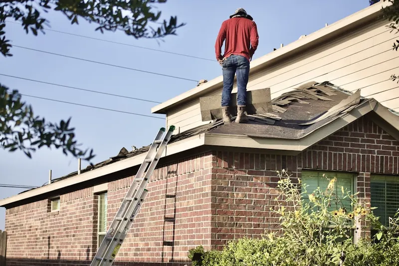 Professional roofer working on a residential roof in Menlo Park Terrace